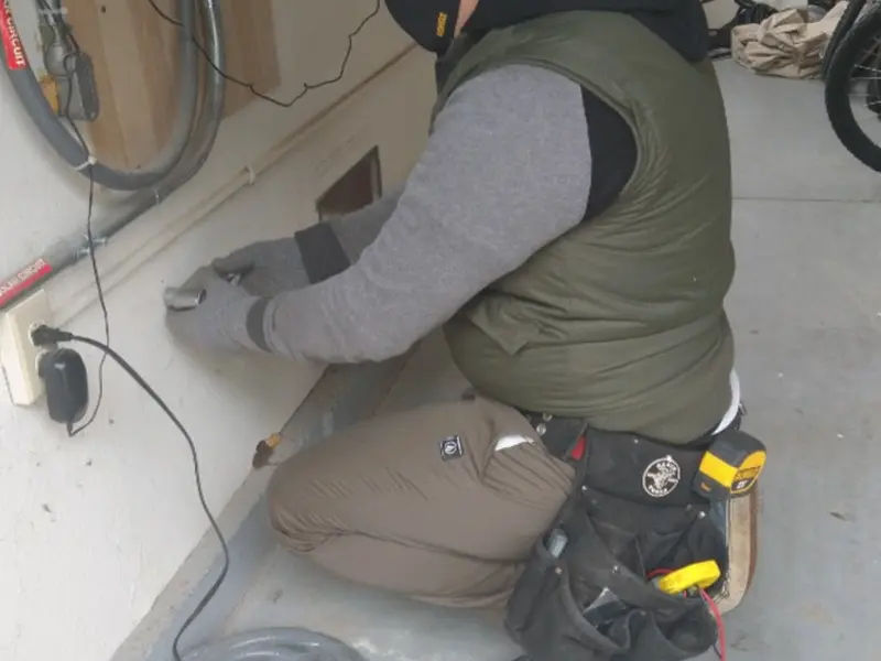 Electrician performing outlet wiring in a Yorkville garage